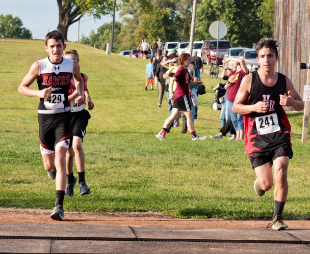 Jakyb Kapp crosses the railroad tracks before heading to the home stretch on the Wartburg Max Course in Waverly. Kapp was part of the Bulldog sophomore boys which finished ninth out of 16 teams competing. (Kristi Nixon/Hampton Chronicle)