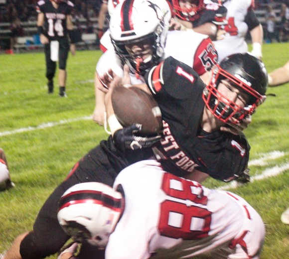 Ian Latham of West Fork is upended by N-P’s Manuel Bibi after gaining a chunk of yardage on Friday night. Against the Huskies, Latham went past the 2,000-yard rushing mark, moving up to second on West Fork’s rushing list in school history. (Kristi Nixon/Hampton Chronicle)